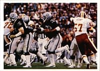 Marcus Allen (center) led the Raiders to a championship in Super Bowl XVIII and earned MVP honors as he rushed for a record of 191 yards, including a memorable 74-yard touchdown run.[56]