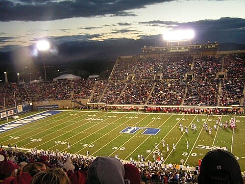 Football game being played at USU's Romney Stadium (now Merlin Olsen Field at Maverik Stadium)