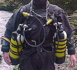 British cave diving style sidemount harness showing snoopy loops used to stow hoses against the cylinders