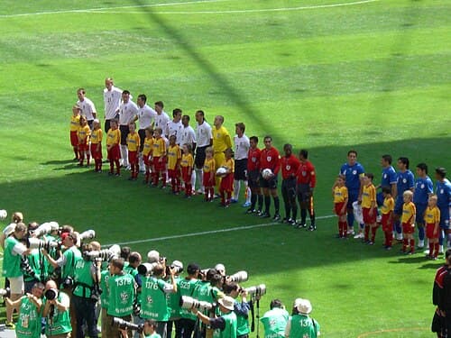 Paraguay (right, in blue) against England (left, in white) before their match at the 2006 FIFA World Cup