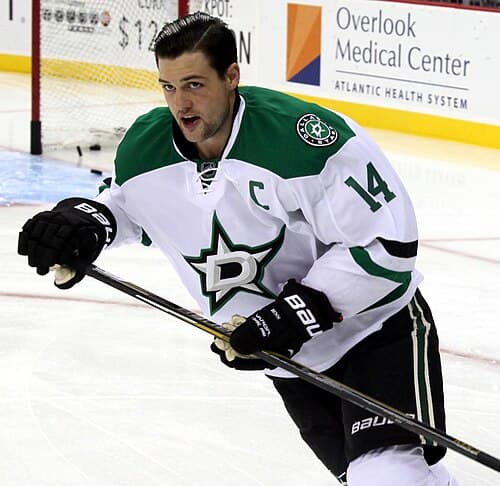 Leading the league in points, Stars' captain Jamie Benn pictured in October 2014. He won the Art Ross Trophy for the 2014–15 season. Benn was also named captain of the Stars prior to the 2013–14 season.