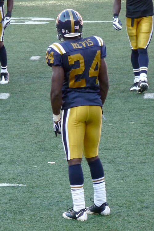 Cornerback Darrelle Revis wearing the New York Titans throwback uniform in 2008. This design combined the original shade of gold from 1960 with the 1961–62 striping modifications