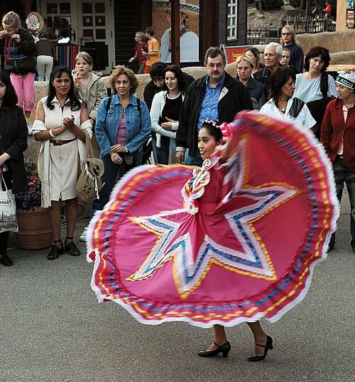 A woman dancing folklórico in the traditional dress of Jalisco