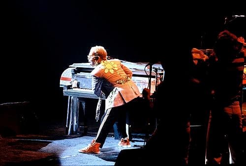 John on the piano during a live performance in 1975