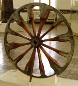 A spoked wheel on display at The National Museum of Iran, in Tehran. The wheel is dated to the late 2nd millennium BCE and was excavated at Choqa Zanbil.
