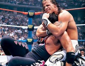 Bret Hart (left) fought Shawn Michaels in a 60-minute Iron Man match for the WWF Championship at WrestleMania XII.