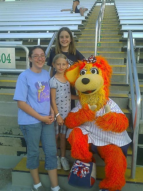 Former mascot Miss-A-Miracle poses for a picture with some young fans