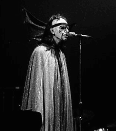 Gabriel in 1974 performing "Watcher of the Skies", dressed in a cape with bat wings and fluorescent makeup